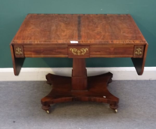 A late William IV brass inlaid rosewood sofa table, with pair of frieze drawers on stepped square column and quatrefoil platform, 97cm wide, 155cm wid