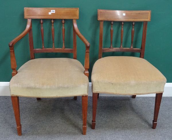 A matched set of eight George III inlaid mahogany dining chairs, with carved and fluted splats on tapering square supports, to include a pair of carve