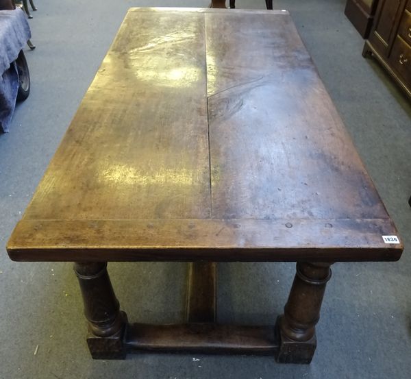 A 17th style oak refectory table, the plank top on turned supports, united by 'H' stretcher, 86cm wide x 184cm long x 74cm high.