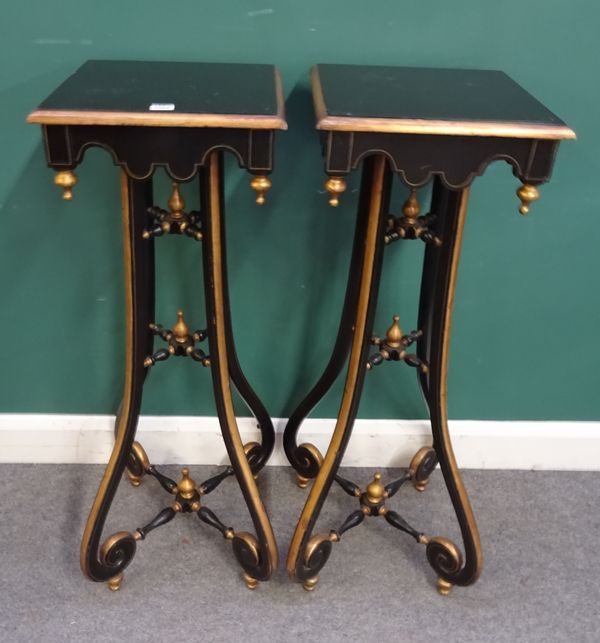 A pair of 20th century parcel gilt ebonised jardiniere stands with square tops and four scroll supports, 40cm wide x 103cm high. (2)