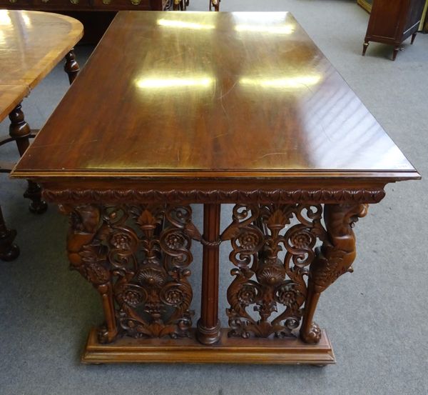 A 17th century Italian style walnut centre table, the rectangular top on a floral carved base with opposing lion monopodia supports, 190cm wide x 101c