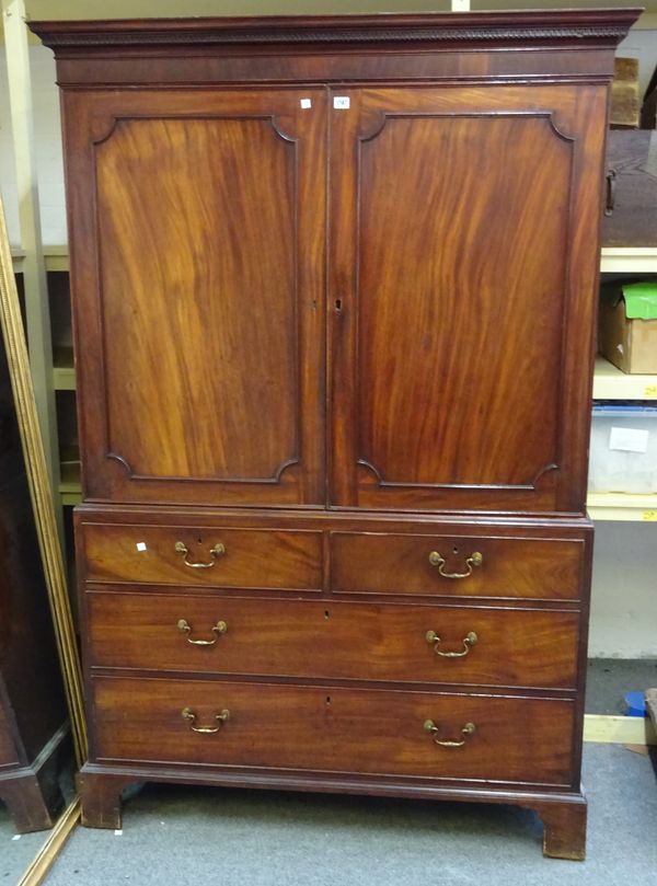 A George III mahogany linen press, with pair of doors over two short and two long drawers, on bracket feet, 129cm wide x 193cm high x 63cm deep.