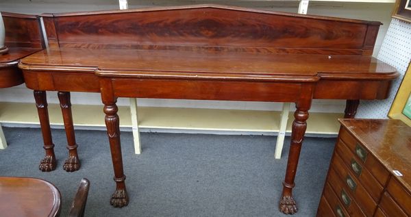 A pair of Regency style mahogany serving tables, each with architectural pointed back over single breakfront frieze drawer, on lappet carved turned co