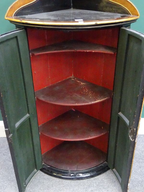 A George III black japanned and chinoiserie decorated bowfront corner cupboard on later stand, the cupboard 60cm wide x 120cm high.