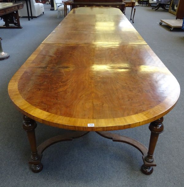 A Queen Anne style inlaid walnut triple section dining table, the crossbanded top over tapering turned columns and shaped 'X' frame stretchers, 125cm