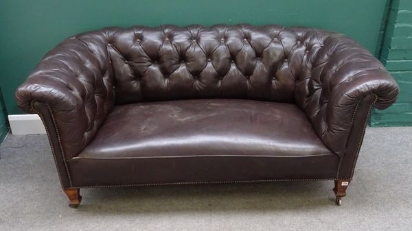 An early 20th century Chesterfield sofa, with brass studded buttoned brown leather upholstery, on tapering square supports, 172cm wide x 73cm high.