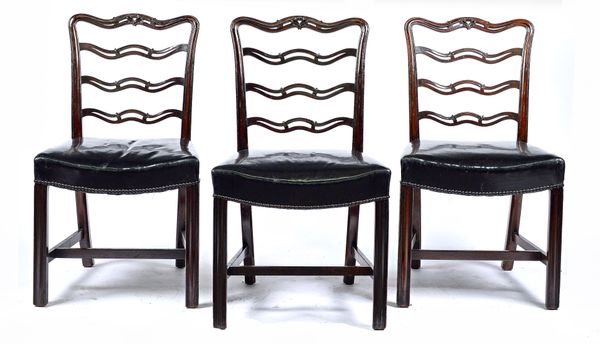 A set of sixteen George II style mahogany dining chairs with pierced wavy splat and concave seat on channelled square supports, to include one carver,