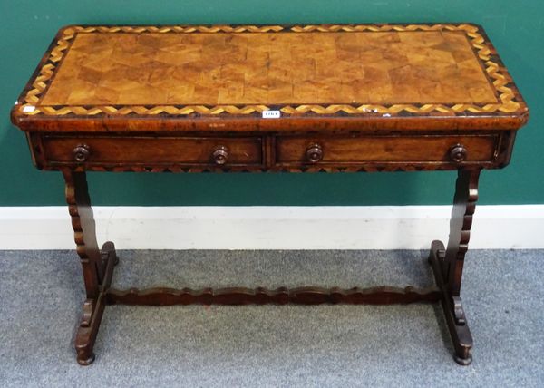 A mid-19th century parquetry inlaid specimen wood two drawer writing table on silhouette trestle end standards, 99cm wide x 44cm diameter x 70cm high.