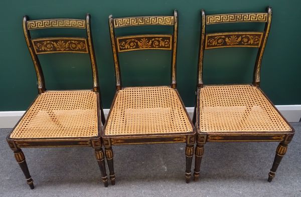 A set of three Regency faux rosewood gilt decorated bar back dining chairs, on turned supports, 47cm wide x 84cm high, (3).