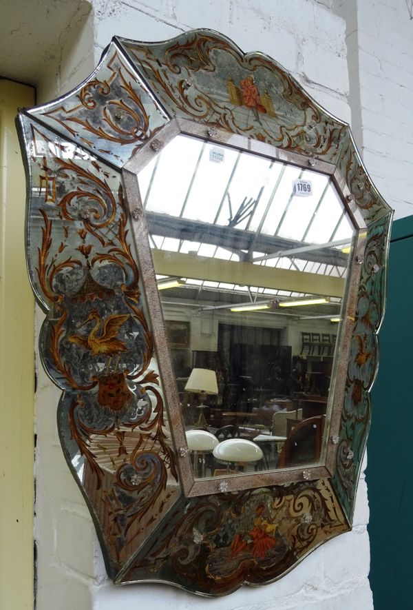 A late 19th century Venetian wall mirror, the shaped swept frame reverse painted with acanthus scrolls, ho-ho birds and figures, 61cm wide x 75cm high