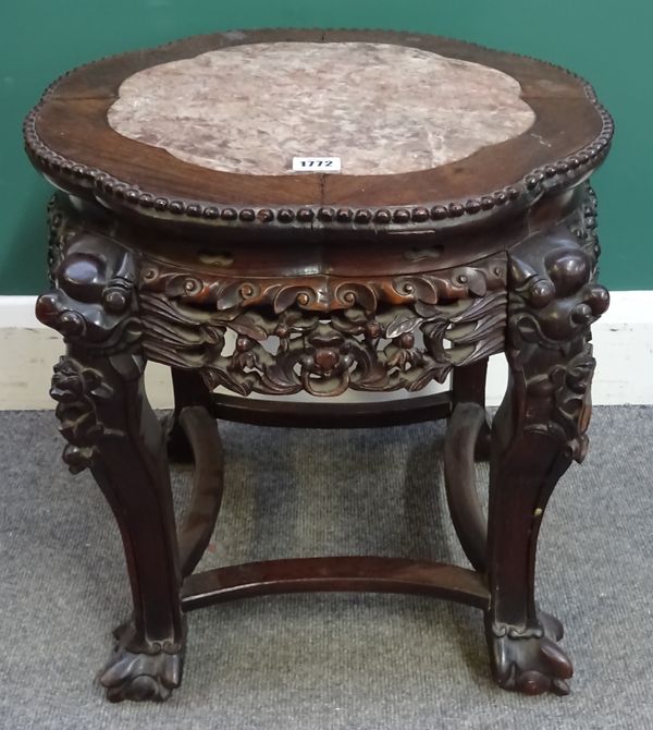 A late 19th century Chinese urn stand, the shaped marble inset top over a pierced and carved base united by concave stretcher, 50cm wide x 47cm high.