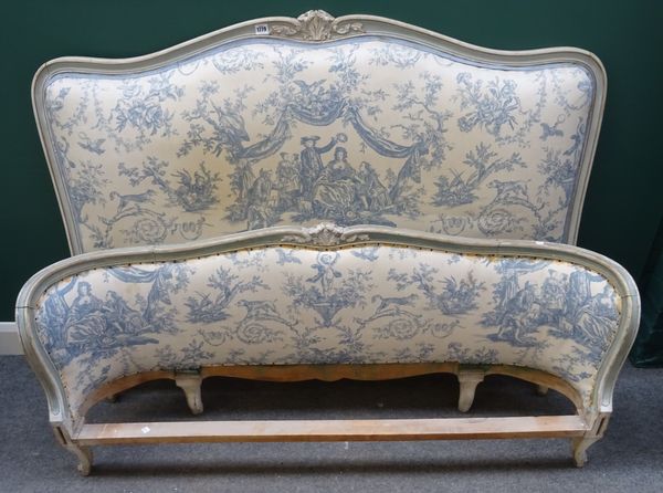 A Louis XVI style double bed, with shell carved padded headboard and bow foot board, 150cm wide x 300cm long.