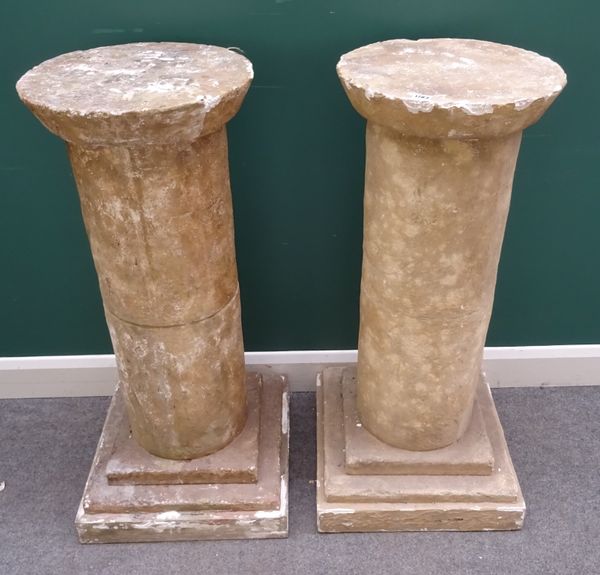 A pair of faux stone pedestals with circular top and column on stepped square base, 50cm wide x 104cm high. (2)