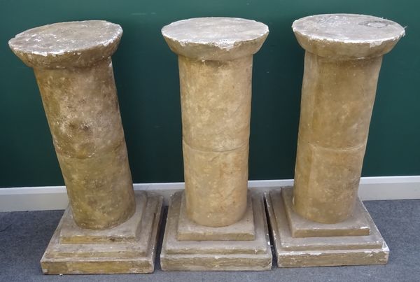 Three faux stone pedestals with circular top and column on stepped square base, 50cm wide x 104cm high, (3).