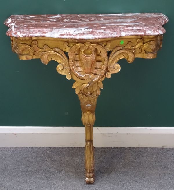 A Louis XV style console table, the shaped marble top on a carved gilt metal monopodia base, 68cm wide x 34cm deep x 83cm high.  1.2