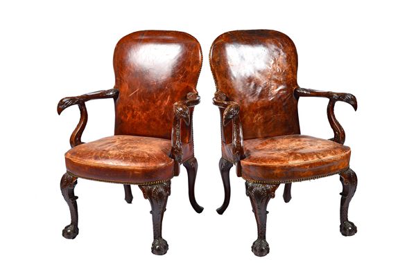 A pair of George I style open armchairs, each with eagle carved arms and bow seat on shell capped cabriole supports and ball and claw feet, 80cm wide