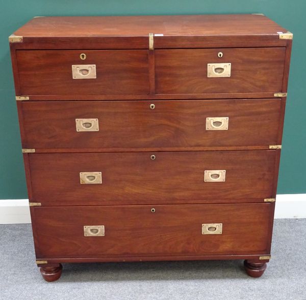 A campaign style metal bound mahogany chest of two short and three long graduated drawers, on turned supports, 106cm wide x 113cm high x 51cm deep.