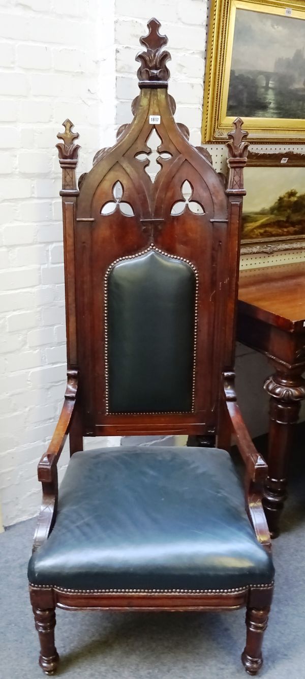 A Victorian mahogany framed high back open arm/throne chair with Gothic Revival carved back, on turned supports, 70cm x 180cm high.