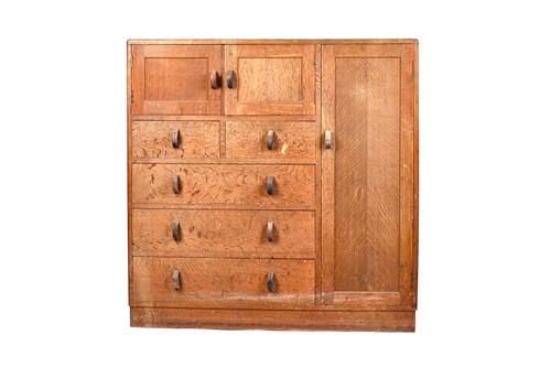 Heals; a mid-20th century oak side cabinet, ivorine maker's disc, with pair of cupboards over two short and three long drawers, flanked to one side by