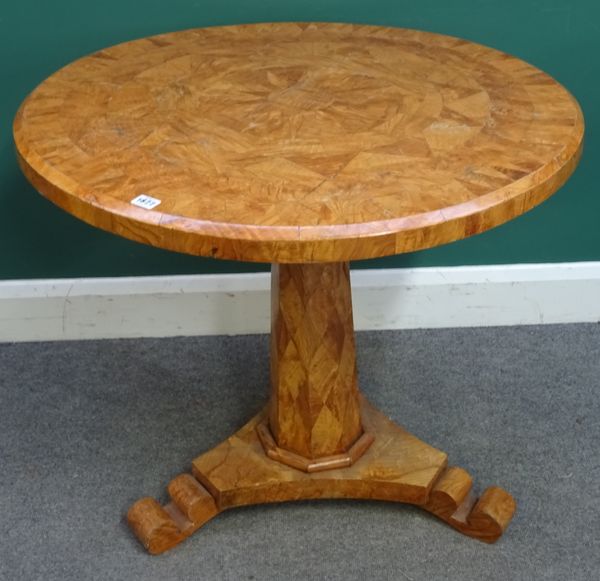 A 19th century and later Continental figured ash circular centre table, the stellar veneered top on tapering octagonal column and quatrefoil platform,