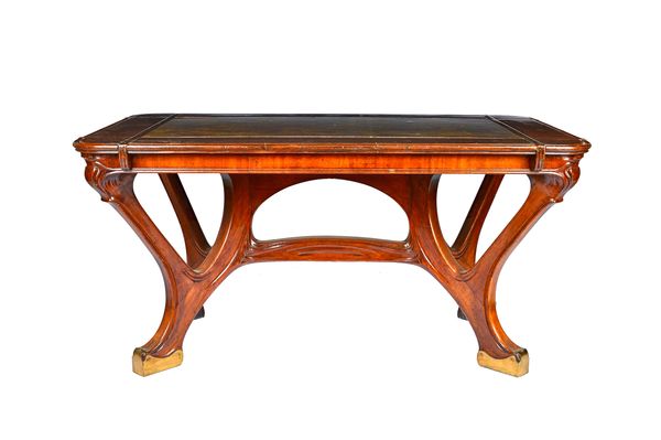 A Continental Art Nouveau design mahogany centre table, the rectangular top with channelled border on four lacquered brass supports united by stretche