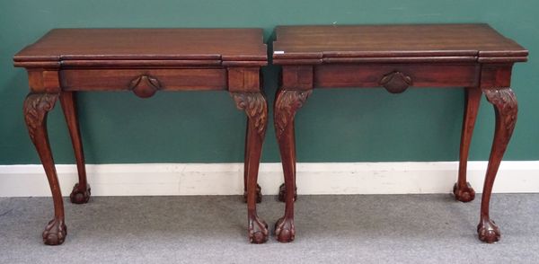 A pair of George I style mahogany tea tables, each with re-entrant rectangular top and frieze drawer, on shell capped cabriole supports and ball and c