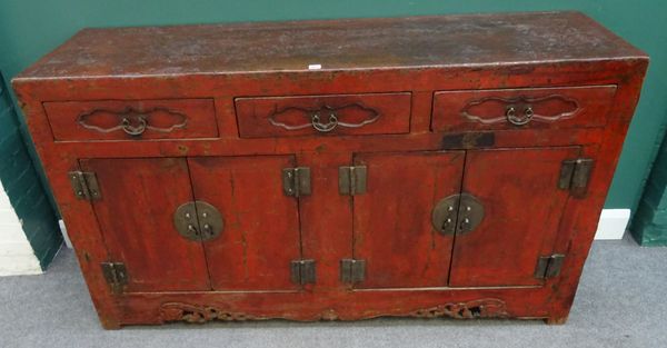 A late 19th century Chinese scarlet lacquered side cabinet, with three drawers over pair of cupboards, above pierced and carved lower frieze, 168cm wi