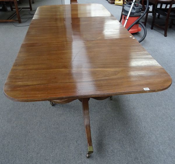 An early 19th century and later mahogany triple pedestal extending dining table, each pedestal with turned column and three downswept supports, to inc