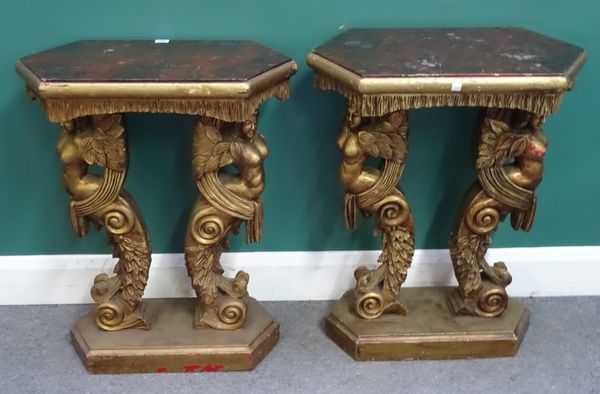 A pair of mid-18th century style gold painted occasional tables/jardiniere stands with faux marble painted tops on opposing caryatid scroll supports,