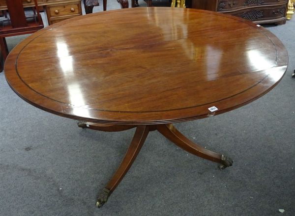 Howard & Sons Ltd; a George III mahogany centre table, the oval top on turned column and four downswept supports, retailer's stamp and plaque to under