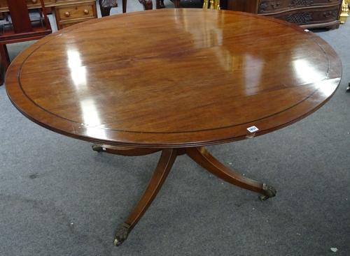 Howard & Sons Ltd; a George III mahogany centre table, the oval top on turned column and four downswept supports, retailer's stamp and plaque to under