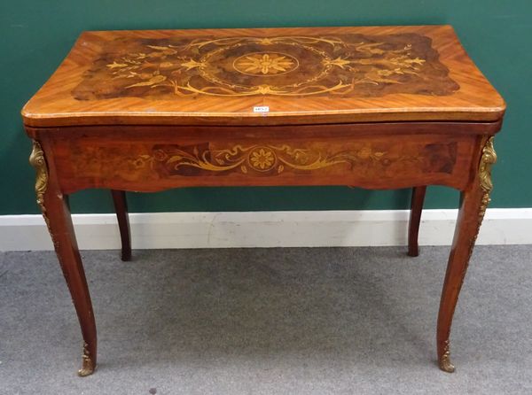 A Louis XV style gilt metal mounted marquetry inlaid figured walnut card table, the serpentine fold over top with shaped frieze, on cabriole supports.