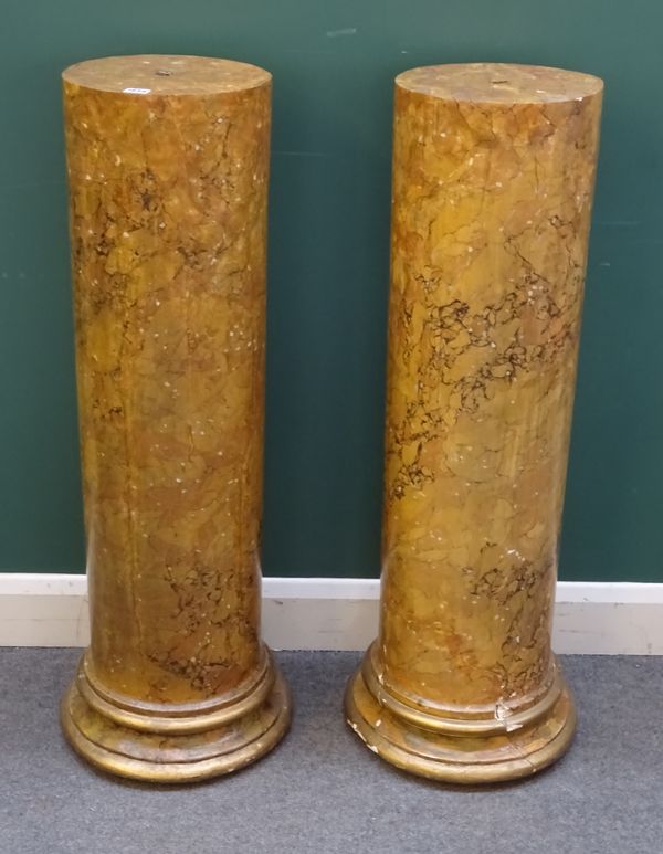 A pair of faux marble turned columns on stepped bases, 39cm wide x 108cm high, (2).