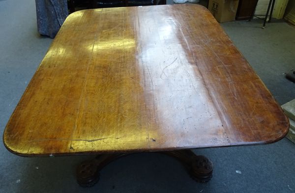 A 19th century oak Gothic Revival centre table, the rectangular snap top on tapering canted square column and quatrefoil platform, with blind tracery