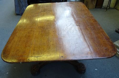A 19th century oak Gothic Revival centre table, the rectangular snap top on tapering canted square column and quatrefoil platform, with blind tracery