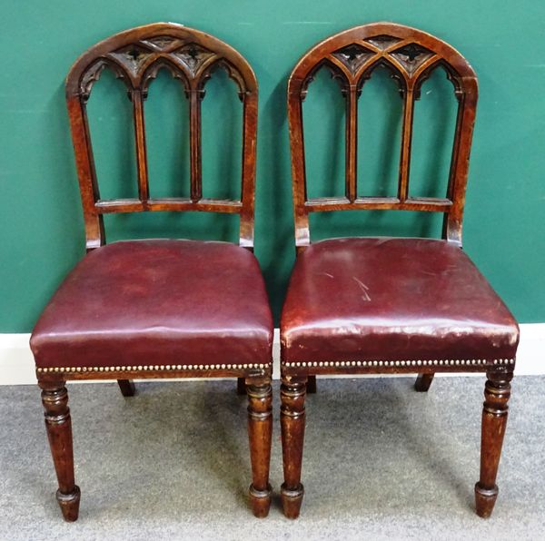 A set of six Victorian oak framed Gothic Revival dining chairs, with pierced arch back on tapering turned supports, (6).