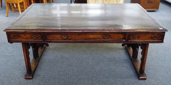 A Victorian oak Gothic Revival centre library table, the leather inset rectangular top with three frieze drawers and matching opposing, on pierced tre