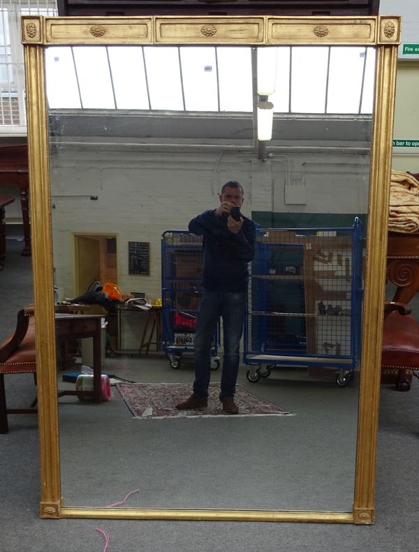 A large 19th century gilt framed rectangular wall mirror, with raised patera mounts, 128cm wide x 182cm high.