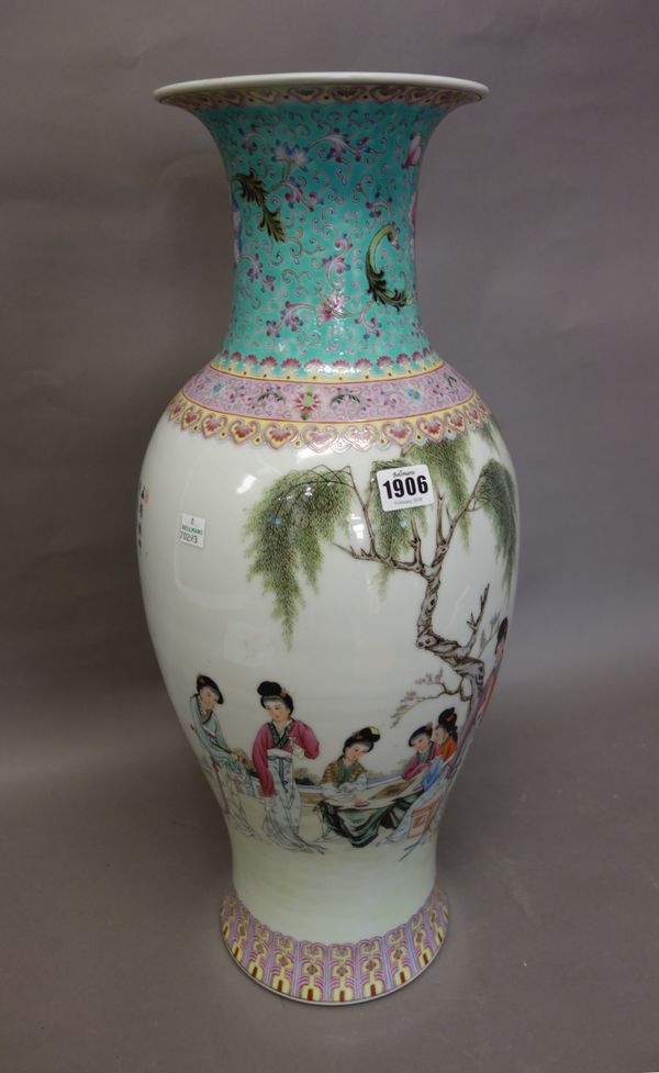 A tall Chinese famille-rose baluster vase, 20th century, painted with young women at leisure in a garden including two seated playing Go, the reverse