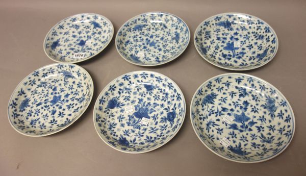 A set of six Chinese blue and white plates, Qing dynasty, 18th century, each painted with scattered flowers and sprigs, 20.5cm. diameter.