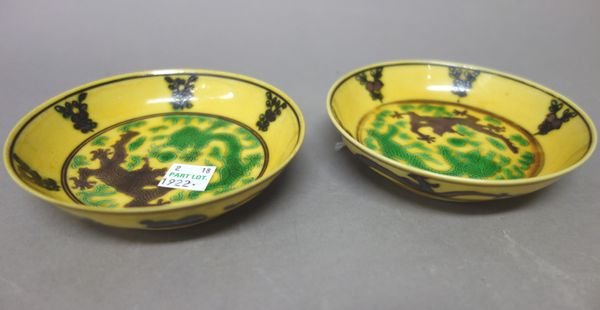 A pair of small Chinese aubergine and green enamelled yellow-ground dragon dishes, Guangxu six character marks, each incised with two dragons chasing