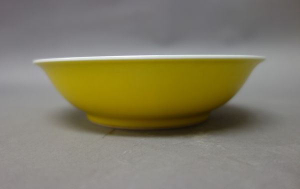 A Chinese yellow-ground saucer, blue six character Guangxu mark, shallow form with everted rim, 16cm. diameter.