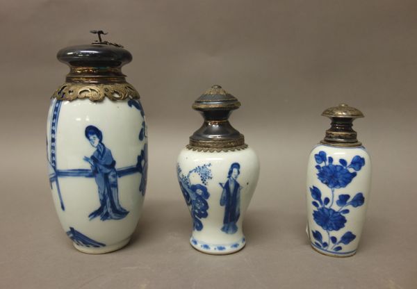 Three Chinese blue and white vases with later silver coloured metal mounts, the porcelain Kangxi, comprising; a  slender ovoid vase painted with two w