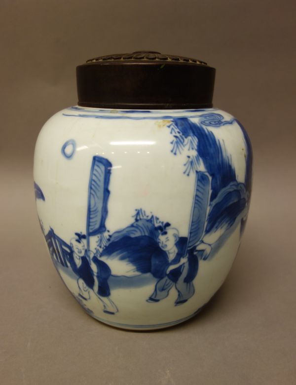 A Chinese blue and white oviform jar, Kangxi, painted with a procession of boys leading a figure riding a mythical beast, 17cm. high, wood cover.