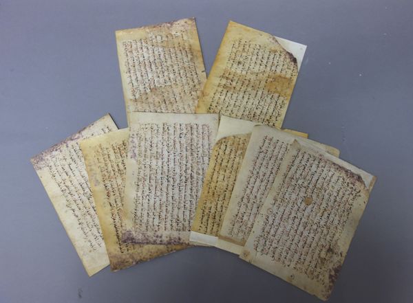 Folios,  North African Qur'an, circa 12th/13th century, eighteen parchment leaves, black script with red highlights, oblong 8vo. 13.5cm. by 20cm, (a.f