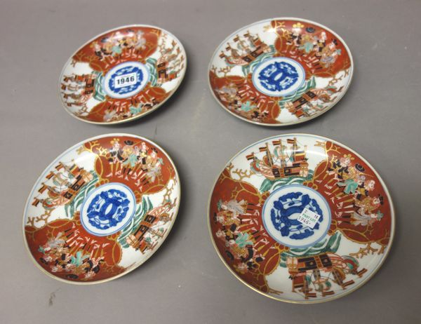 A group of nine Japanese Imari `black ship' bowls and covers and four stands or plates, Meiji period, the bowls of slightly varying size, painted with