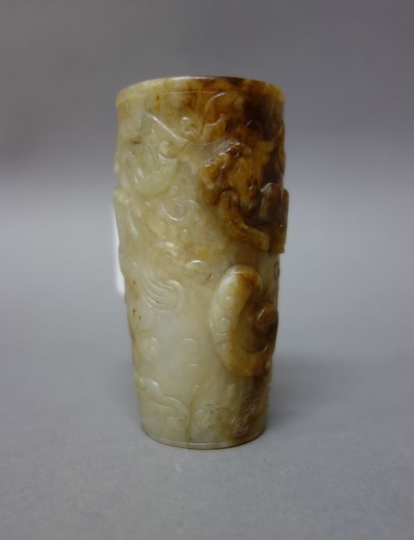 A small Chinese jade cylindrical vase, 18th/19th century, the stone of greyish tone with russet inclusions, carved with chilong amongst cloud scrolls,