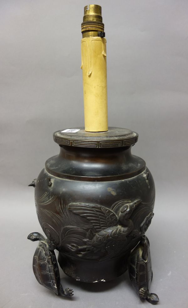 A Japanese bronze vase, Meiji period, the bulbous body decorated in relief with birds in flight, raised on three terrapin supports, 25cm. high, fitted