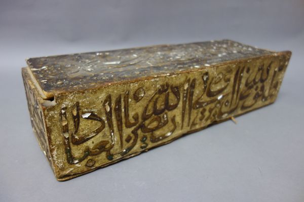 An Ottoman gessoed wooden box and sliding cover, possibly 17th century. of rectangular form, the sides and cover with calligraphy, 45cm. length.