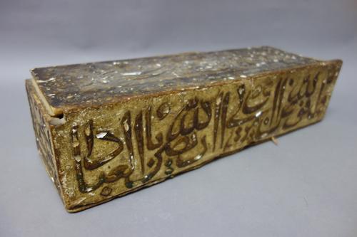 An Ottoman gessoed wooden box and sliding cover, possibly 17th century. of rectangular form, the sides and cover with calligraphy, 45cm. length.
